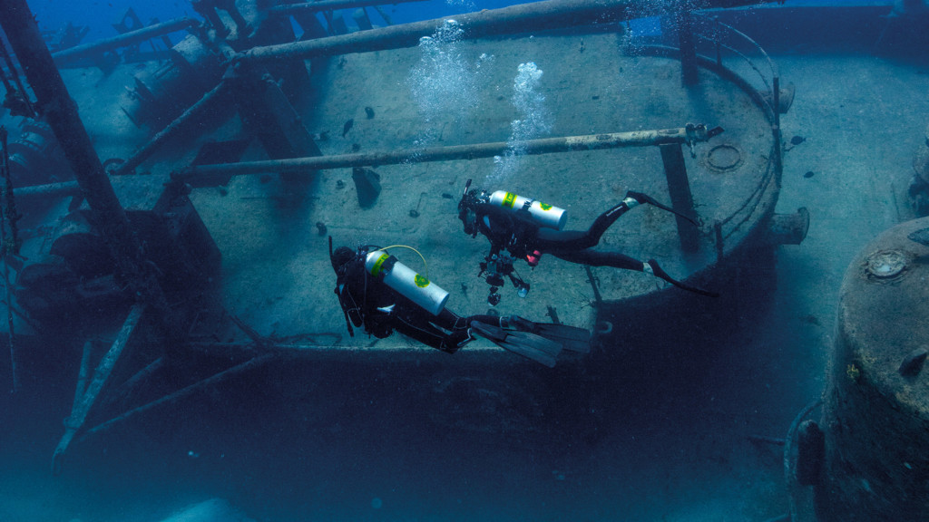 Two-divers-swimming-above-a-wreck-1024x576.jpg